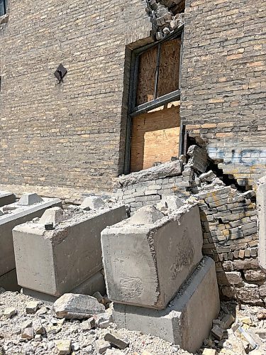 TYLER SEARLE / FREE PRESS

Residents living near 579 McDermot Ave. were forced to evacuate last week after the City of Winnipeg received an engineering assessment confirming the building was unsafe. Lanes and sidewalks around the property have been blocked with fencing. Large concrete blocks line the east exterior wall in an apparent effort to support the structure and prevent a collapse. 
July 11, 2024
