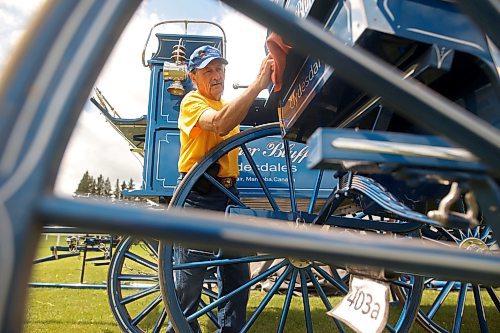 Calvin Martin of Boulder Bluff Clydesdales in Strathclair polishes his cart prior to the heavy horse driving demonstrations at the 136th Annual Strathclair Ag Society Fair on Tuesday. The Strathclair Ag Society Fair is one of six stops for the annual Milk Run, a six-day-long series of town fairs in close proximity. The other fairs include Oak River, Shoal Lake, Hamiota, Harding and Oak Lake. The Strathclair fair included a light horse show, a beef show, a heavy horse driving demonstration and a wide variety of entertainment, games and other activities. (Tim Smith/The Brandon Sun)