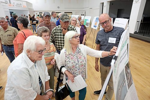 Donovan Toews (right), managing partner with Landmark Planning & Design, speaks with Westman residents during the public open house and consultation on Tuesday evening. (Tim Smith/The Brandon Sun)