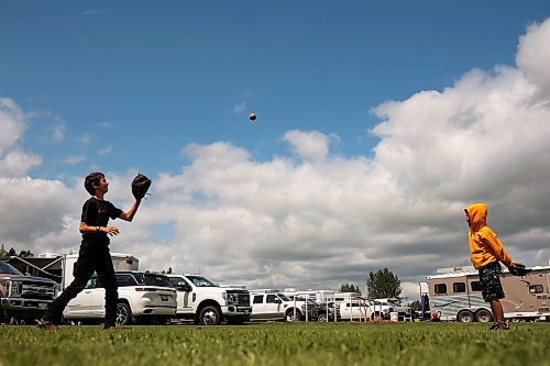 16072024
David Thiessen and Hunter Ariss play catch at the 136th Annual Strathclair Ag Society Fair on Tuesday. The Strathclair Ag Society Fair is one of six stops for the annual Milk Run, a six day long series of town fairs in close proximity. The other fairs include Oak River, Shoal Lake, Hamiota, Harding and Oak Lake. The Strathclair fair included a light horse show, a beef show, a heavy horse driving demonstration and a wide variety of entertainment, games and other activities. 
(Tim Smith/The Brandon Sun)