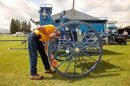 16072024
Calvin Martin of Boulder Bluff Clydesdales in Strathclair polishes his cart prior to the heavy horse driving demonstrations at the 136th Annual Strathclair Ag Society Fair on Tuesday. The Strathclair Ag Society Fair is one of six stops for the annual Milk Run, a six day long series of town fairs in close proximity. The other fairs include Oak River, Shoal Lake, Hamiota, Harding and Oak Lake. The Strathclair fair included a light horse show, a beef show, a heavy horse driving demonstration and a wide variety of entertainment, games and other activities. 
(Tim Smith/The Brandon Sun)