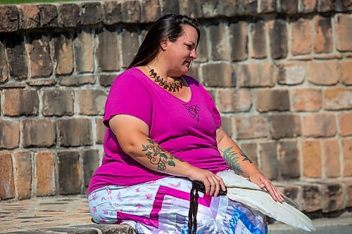 BROOK JONES / FREE PRESS
Jaime Grasby, 43, who is an indigenous story teller and knowledge keeper is pictured with smuding feather fans as she sits in the Oodena Celebration Circle at The Forks in Winnipeg, Man., Thursday, July 11, 2024.