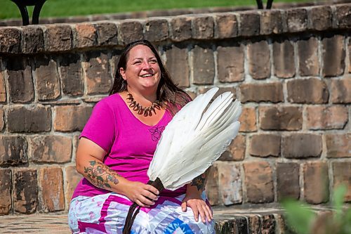 BROOK JONES / FREE PRESS
Jaime Grasby, 43, who is an indigenous story teller and knowledge keeper smiles while holding smuding feather fans while she is pictured in the Oodena Celebration Circle at The Forks in Winnipeg, Man., Thursday, July 11, 2024.