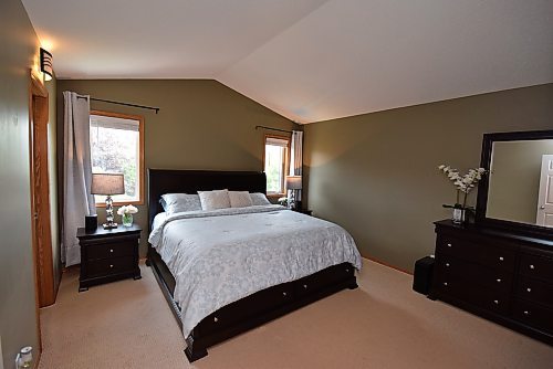 Todd Lewys / Winnipeg Free Press



The secluded primary bedroom comes with a vaulted ceiling, alluring air of tranquility and an elevated view of the gorgeous backyard.