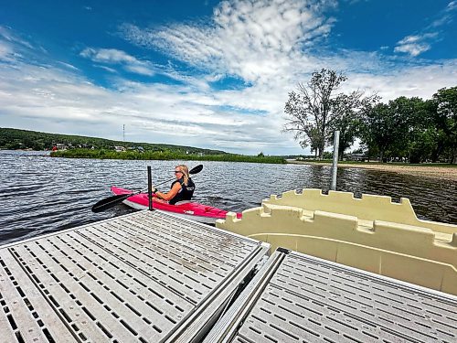 Erliss Stobbe, the secretary and treasurer of the volunteer group Friends of Lake Minnedosa, uses the community's new kayak launch on a warm and sunny day in July. (Sofia Frolova/For The Brandon Sun)