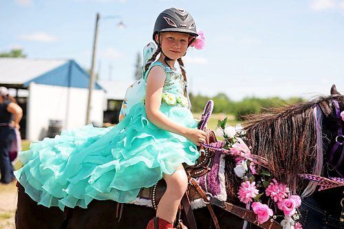 Seven-year-old Amelia Coey of Minnedosa and her quarter pony Jellybean wait to compete in the miniature horse judging seven-and-under costume class at the Shoal Lake Ag Society Fair on Wednesday. The Shoal Lake Fair is one of six stops for the annual Milk Run, a six-day-long series of town fairs in close proximity. The Milk Run continues today with the Hamiota Fair. See more photos on Page A4. (Tim Smith/The Brandon Sun)