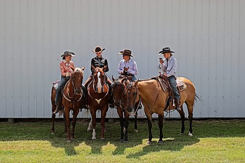 Cassie Dudar, Leena Badowski, Cole Dudar and Emma Dudar chat atop their horses while waiting to compete in the light horse show judging. (Tim Smith/The Brandon Sun)