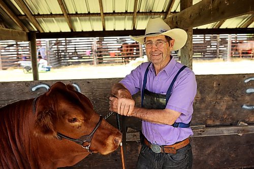 Everett More of Virden and his Simmental bred yearling More’s Ms. Layla 320L after competing in the cattle judging junior yearling category. (Tim Smith/The Brandon Sun)