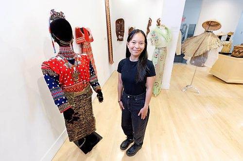 MIKE DEAL / FREE PRESS
Ana Ilagan, communications and engagement assistant at the Manitoba Crafts Museum and Library who curated, Lupa ay Buhay | Land is Life, exhibition showcasing Filipino culture through its rich craft traditions. The exhibit will be on display August 28, 2024 at the Shirley Richardson Craft Gallery on 329 Cumberland Avenue.

The mannequin Ana is standing beside is decked out in clothing from the T'boli people of South Cotobato, Mindanao in the southern part of the Philippines who are known to be a colourful group. Their garments and jewelry are characterized by bright red colours, geometric patterns and brass adornments that are passed down from generation to generation. The pieces are mid-20th century.
240717 - Wednesday, July 17, 2024.