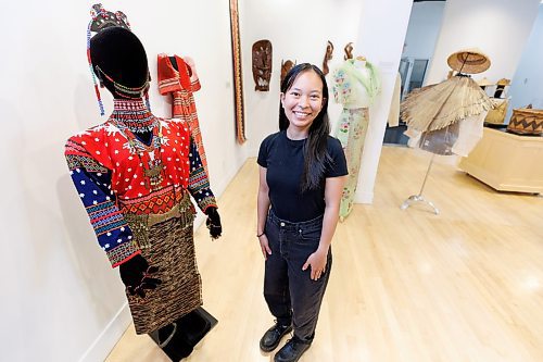 MIKE DEAL / FREE PRESS
Ana Ilagan, communications and engagement assistant at the Manitoba Crafts Museum and Library who curated, Lupa ay Buhay | Land is Life, exhibition showcasing Filipino culture through its rich craft traditions. The exhibit will be on display August 28, 2024 at the Shirley Richardson Craft Gallery on 329 Cumberland Avenue.

The mannequin Ana is standing beside is decked out in clothing from the T'boli people of South Cotobato, Mindanao in the southern part of the Philippines who are known to be a colourful group. Their garments and jewelry are characterized by bright red colours, geometric patterns and brass adornments that are passed down from generation to generation. The pieces are mid-20th century.
240717 - Wednesday, July 17, 2024.