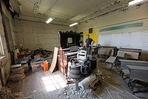 Rapid City Museum and Cultural Centre board member Duncan Martin, who is on the building committee for the board, looks over some of the museum pieces stored in one of the former classrooms in the former Rapid City public school building that is currently under restoration and construction work by the board, during a tour of the structure on July 15. (Matt Goerzen/The Brandon Sun)