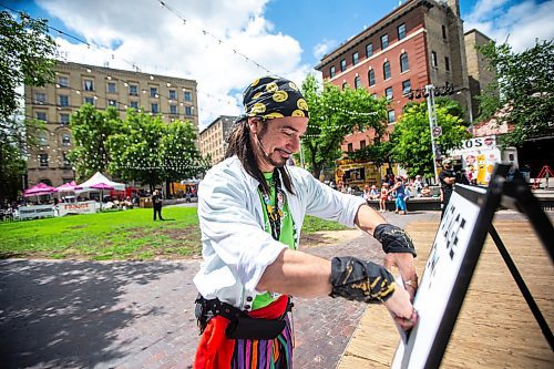 MIKAELA MACKENZIE / FREE PRESS

Captain Braggadocio, a.k.a. Tim Webster, changes the sandwich board at the Old Market Square outdoor stage as Fringe festival launches in Winnipeg on Wednesday, July 17, 2024.

