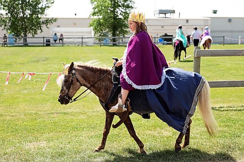 17072024
Six-year-old Victoria Thiessen of Griswold makes her way to the paddock atop her pony Sally Rose to take part in the seven-and-under costume class at the Shoal Lake Ag Society Fair on Wednesday. The Shoal Lake Fair is one of six stops for the annual Milk Run, a six day long series of town fairs in close proximity. The Milk Run continues today with the Hamiota Fair. (Tim Smith/The Brandon Sun)