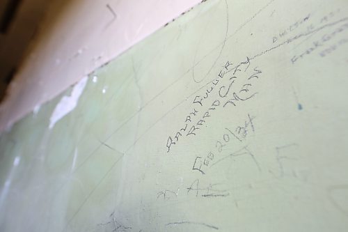 Top right: While taking out some of the heavy straw board that lined the walls on the second floor of the former Rapid City public school building, board uncovered a treasure trove of signatures from the 1930s on one particular wall that they are now trying to preserve. One of the signatures was written by a man named Ralph Fuller, a Rapid City resident and Canadian soldier who was killed by the Nazis during the Second World War by firing squad in 1944, according to local history. (Matt Goerzen/The Brandon Sun)