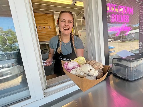 A staffer laughs while holding a Joe Dandy's Drive-In specialty,&#x2b4;he Ice Cream Flight &#x44a;four scoops of hard ice cream served in a cardboard dish. In this case, the four flavours included Cherry Cheesecake, mocha almond fudge, chocolate chip cookie dough and lavendar lemonade. Careful with this one &#x44a;it's heavy! (Matt Goerzen/The Brandon Sun)