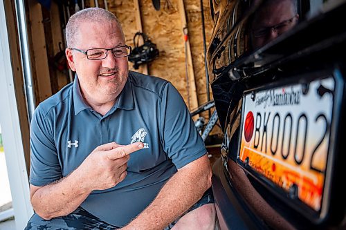 NIC ADAM / FREE PRESS
Adam Wedlake, Executive Director of Basketball Manitoba, pictured next to his basketball licence plate Thursday afternoon. His is the second the province ever made.
240718 - Thursday, July 18, 2024.

Reporter: Jura