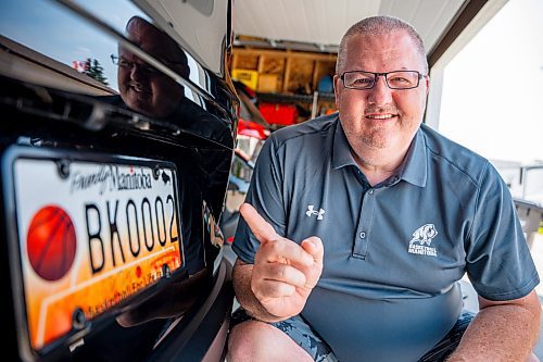 NIC ADAM / FREE PRESS
Adam Wedlake, Executive Director of Basketball Manitoba, pictured next to his basketball licence plate Thursday afternoon. His is the second the province ever made.
240718 - Thursday, July 18, 2024.

Reporter: Jura