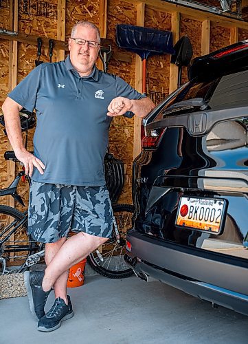 NIC ADAM / FREE PRESS
Adam Wedlake, Executive Director of Basketball Manitoba, pictured next to his basketball licence plate Thursday afternoon. His is the second the province ever made.
240718 - Thursday, July 18, 2024.

Reporter: Jura