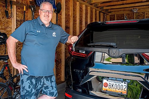 NIC ADAM / FREE PRESS
Adam Wedlake, Executive Director of Basketball Manitoba, pictured next to his basketball licence plate Thursday afternoon. His is the second the province ever made.
240718 - Thursday, July 18, 2024.

Reporter: Jura