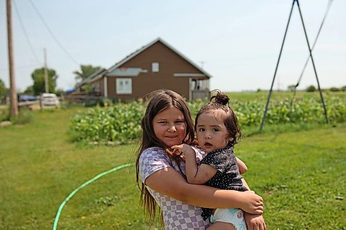 18072024
Leilani Taylor holds her sister Ivy Giesbrecht while playing in a wading pool at their home at Sioux Valley Dakota Nation on a hot Thursday afternoon. 
(Tim Smith/The Brandon Sun)