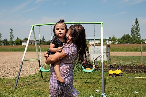 18072024
Leilani Taylor holds her sister Ivy Giesbrecht while playing in a wading pool at their home at Sioux Valley Dakota Nation on a hot Thursday afternoon. 
(Tim Smith/The Brandon Sun)