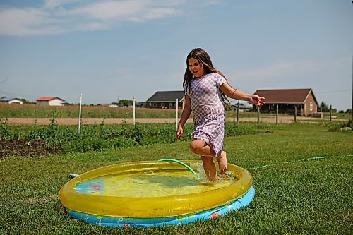 18072024
Leilani Taylor runs through the cool water in a wading pool in front of her home at Sioux Valley Dakota Nation on a hot Thursday afternoon. 
(Tim Smith/The Brandon Sun)