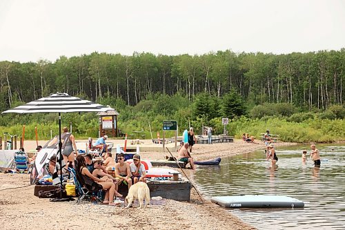 Beachgoers enjoy the hot weather and cool water at the Clear Lake boat cove in Riding Mountain National Park on Friday. (Tim Smith/The Brandon Sun)
