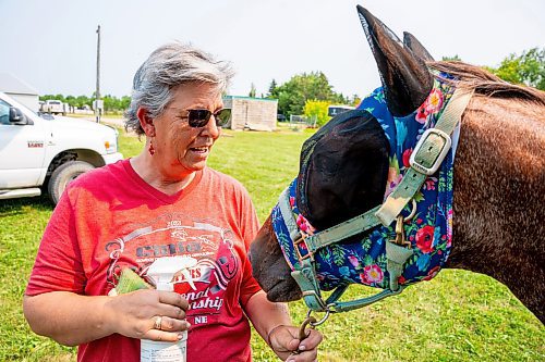 NIC ADAM / FREE PRESS
Cowboy Mounted Shooting Association president Herma Zomer pictured alongside her horse Lil’ Red at the Manitoba Stampede & Exhibition Friday afternoon.
240719 - Friday, July 19, 2024.

Reporter: Jura