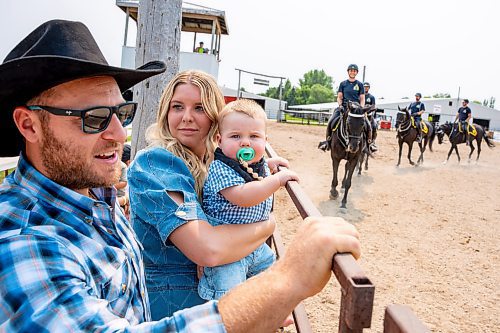 NIC ADAM / FREE PRESS
Mads Nicolaisen, Raena Knott, and Noah Nicolaisen (from left) watch members of the RCMP musical ride practice before their show at the Manitoba Stampede & Exhibition Friday afternoon.
240719 - Friday, July 19, 2024.

Reporter: Jura