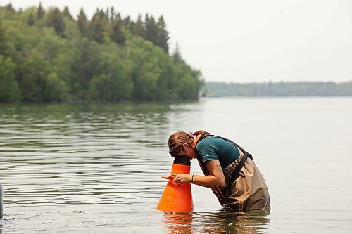 19072024
Parks Canada employees conduct visual inspections for signs of zebra mussels near the Clear Lake boat cove in Riding Mountain National Park on Friday. Parks Canada announced Friday that they had found evidence of localized zebra mussel infiltration at the boat cove.
(Tim Smith/The Brandon Sun)
