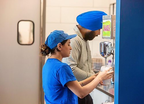 BROOK JONES / FREE PRESS
Boardwalk Fries Burgers Shakes at the Park West Shopping Centre located at 6650 Roblin Blvd. in Winnipeg, Man.,  is celebrating its grand opening Friday, July 19, 2024. Store manager Manpreet Kamob is pictured making a milkshake. while franchisee Garry Cheema is pictured in the background.