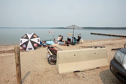 19072024
Beach goers enjoy the hot weather and cool water at the Clear Lake boat cove in Riding Mountain National Park on Friday as wooden poles and concrete barriers prevent boat launches into the lake. Parks Canada announced Friday that they had found evidence of localized zebra mussel infiltration at the boat cove. 
(Tim Smith/The Brandon Sun)
