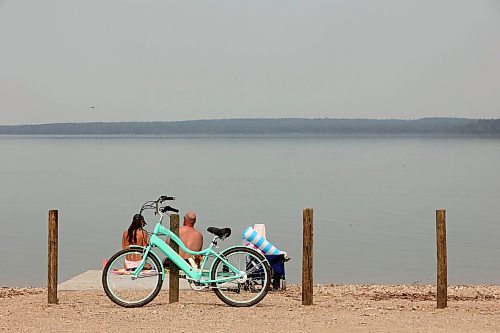 19072024
Beach goers enjoy the hot weather and cool water at the Clear Lake boat cove in Riding Mountain National Park on Friday as wooden poles and concrete barriers prevent boat launches into the lake. Parks Canada announced Friday that they had found evidence of localized zebra mussel infiltration at the boat cove. 
(Tim Smith/The Brandon Sun)
