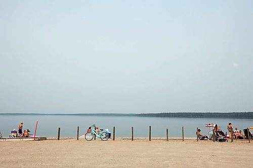 19072024
Beach goers enjoy the hot weather and cool water at the Clear Lake boat cove in Riding Mountain National Park on Friday as wooden poles and concrete barriers prevent boat launches into the lake. Parks Canada announced Friday that they had found evidence of localized zebra mussel infiltration at the boat cove. 
(Tim Smith/The Brandon Sun)
