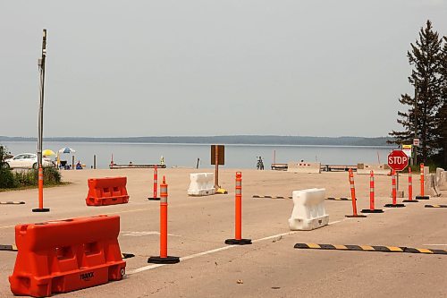 19072024
Beach goers enjoy the hot weather and cool water at the Clear Lake boat cove in Riding Mountain National Park on Friday as wooden poles and concrete barriers prevent boat launches into the lake. Parks Canada announced Friday that they had found evidence of localized zebra mussel infiltration at the boat cove. 
(Tim Smith/The Brandon Sun)
