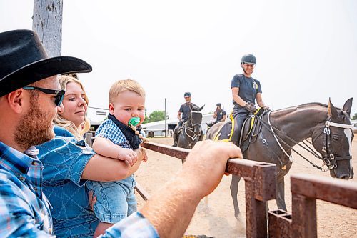 NIC ADAM / FREE PRESS
Mads Nicolaisen, Raena Knott, and Noah Nicolaisen (from left) watch members of the RCMP musical ride practice before their show at the Manitoba Stampede &amp; Exhibition Friday afternoon.
240719 - Friday, July 19, 2024.

Reporter: Jura