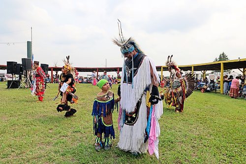 A father and son step into the centre of Rolling RIver First Nation's powwow arbour to dance together on Saturday. (Colin Slark/The Brandon Sun)