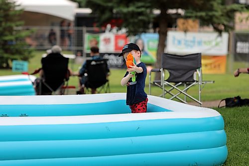 A boy with a water gun takes aim at the Salamander Summer Music Festival at Rideau Park in Brandon on Sunday. (Colin Slark/The Brandon Sun)