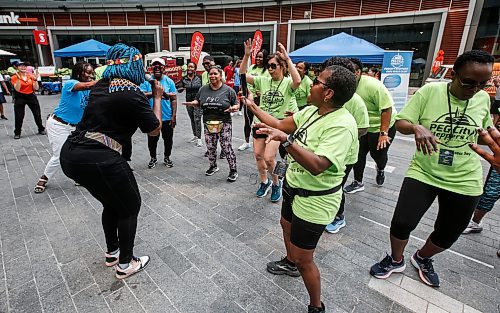 JOHN WOODS / FREE PRESS
Nosipho Mtotoba from Soweto leads in a song and dance session with members of Pegcity Steppers at their Health And Wellness Day event at True North Square Sunday, July 21, 2024. 

Reporter: