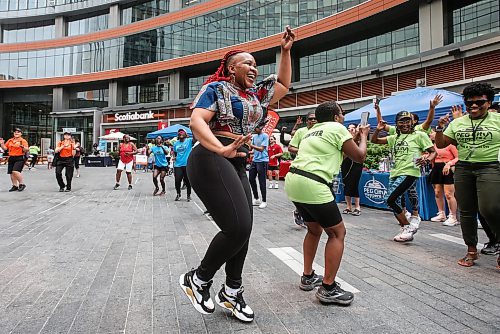 JOHN WOODS / FREE PRESS
Tiny Modise from Soweto leads in a song and dance session with members of Pegcity Steppers at their Health And Wellness Day event at True North Square Sunday, July 21, 2024. 

Reporter: