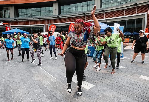 JOHN WOODS / FREE PRESS
Tiny Modise from Soweto leads in a song and dance session with members of Pegcity Steppers at their Health And Wellness Day event at True North Square Sunday, July 21, 2024. 

Reporter: