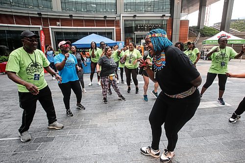 JOHN WOODS / FREE PRESS
Nosipho Mtotoba from Soweto leads in a song and dance session with members of Pegcity Steppers at their Health And Wellness Day event at True North Square Sunday, July 21, 2024. 

Reporter: