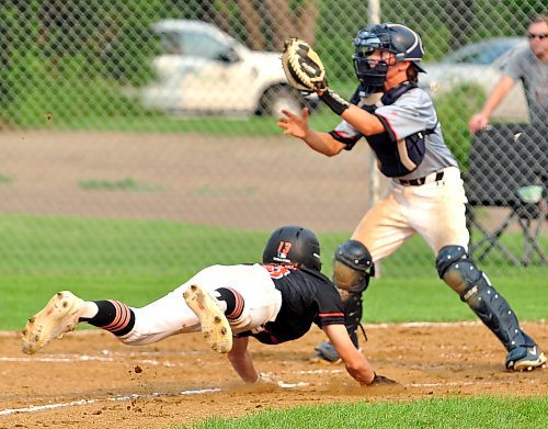 Jackson Burgess takes flight sliding to the plate during his team's 15-8 loss to the Interlake Orioles on Day 2 of the 15U AAA provincial qualifying tournament in Glenboro. When the ball finally arrived, the catcher as able to apply a tag and Burgess was called out by the umpire. (Jules Xavier/The Brandon Sun)