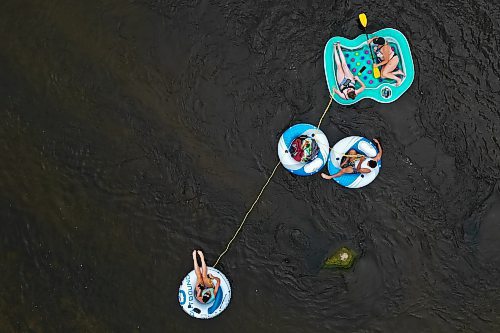 Friends Loren Lobreau (from left), Jodie Tocher, Luis Alvarenga and Cassandra Kowalchuk float down the Little Saskatchewan River west of Brandon on a hot and humid Monday afternoon. (Tim Smith/The Brandon Sun)