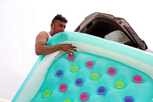 22072024
Luis Alvarenga inflates a raft at Kirkham Bridge west of Brandon for rafting down the Little Saskatchewan River with friends on a hot and humid Monday afternoon. 
(Tim Smith/The Brandon Sun)