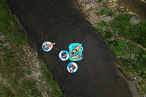 22072024
(clockwise from top left) Friends Loren Lobreau, Cassandra Kowalchuk, Jodie Tocher and Luis Alvarenga float down the Little Saskatchewan River west of Brandon on a hot and humid Monday afternoon. 
(Tim Smith/The Brandon Sun)