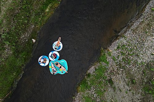 22072024
(clockwise from top) Friends Loren Lobreau, Cassandra Kowalchuk, Jodie Tocher and Luis Alvarenga float down the Little Saskatchewan River west of Brandon on a hot and humid Monday afternoon. 
(Tim Smith/The Brandon Sun)default