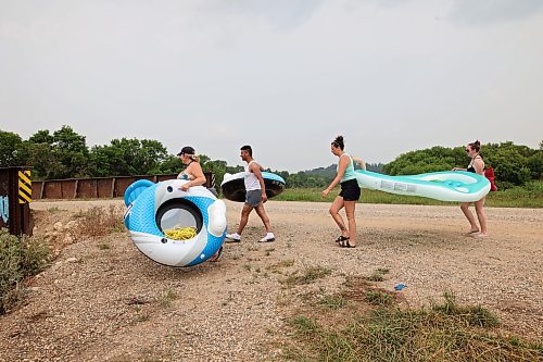 22072024
Friends Cassandra Kowalchuk, Luis Alvarenga, Loren Lobreau and Jodie Tocher carry rafts to the water at Kirkham Bridge west of Brandon for floating down the Little Saskatchewan River on a hot and humid Monday afternoon. 
(Tim Smith/The Brandon Sun)