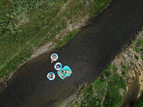 22072024
(clockwise from top) Friends Loren Lobreau, Cassandra Kowalchuk, Jodie Tocher and Luis Alvarenga float down the Little Saskatchewan River west of Brandon on a hot and humid Monday afternoon. 
(Tim Smith/The Brandon Sun)