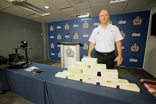 Winnipeg police Insp. Elton Hall shows off kilograms of cocaine seized from baggage at the city's airport. ERIK PINDERA / WINNIPEG FREE PRESS